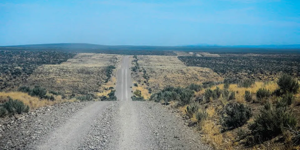 Long gravel road through open Idaho landscape